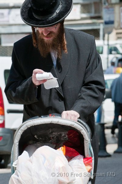 20100409_111607 D300.jpg - Man pushing stroller and checking out shopping list